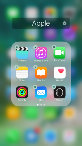 You can delete these default apps by holding down on an app icon then pressing the "x" button. 