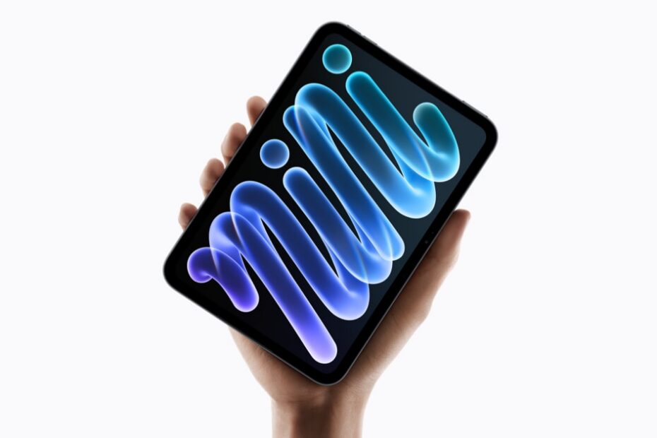 A hand holding the new iPad mini against a white background, its screen showing a glowing blue and purple swirl that spells out the word mini